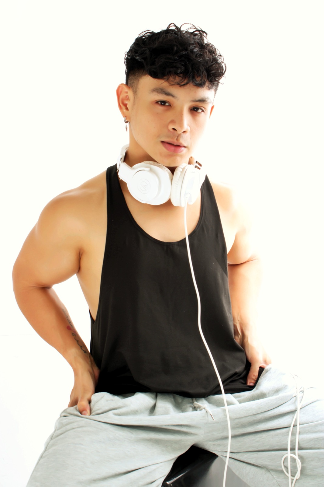 Paolo Domingo seated with white headphones